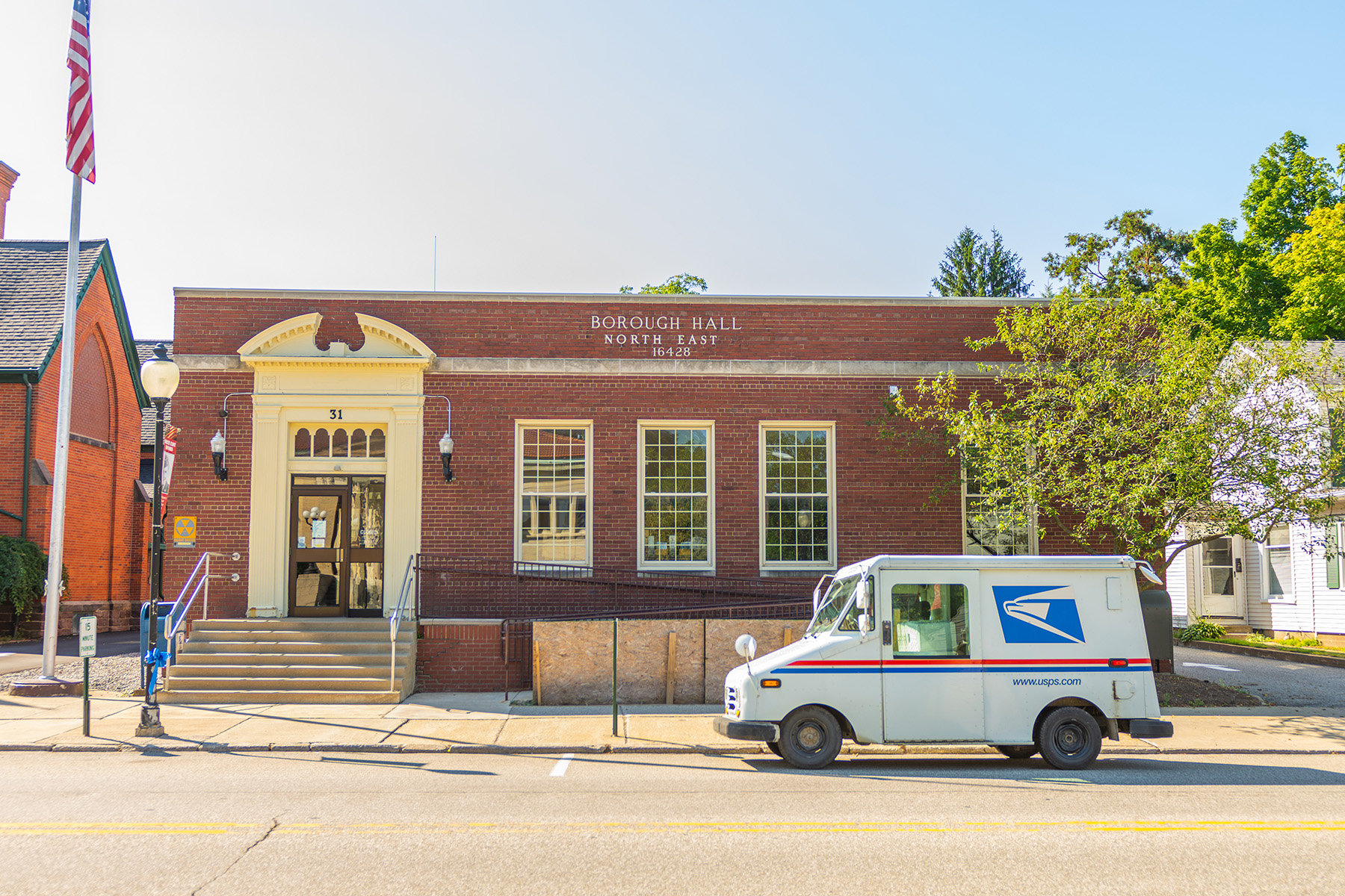 Borough hall in downtown north east with a postal truck out front of it