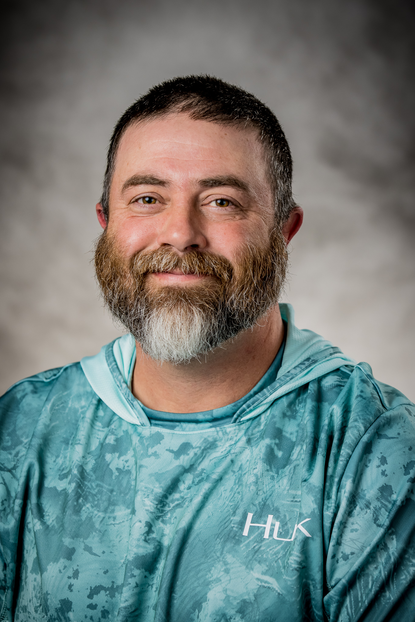 man with bread wearing tie-dyed hoodie