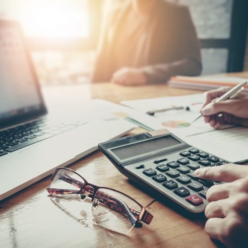 stock image of a person typing in numbers on a calculator